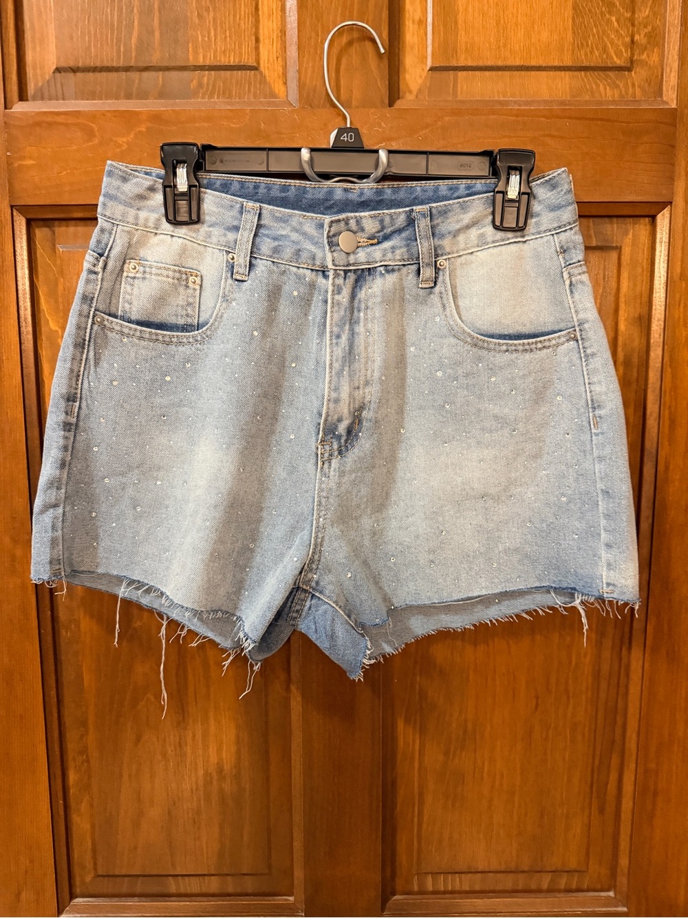 Womenโs Light Blue Denim High-Waist Shorts with Rhinestone Detail